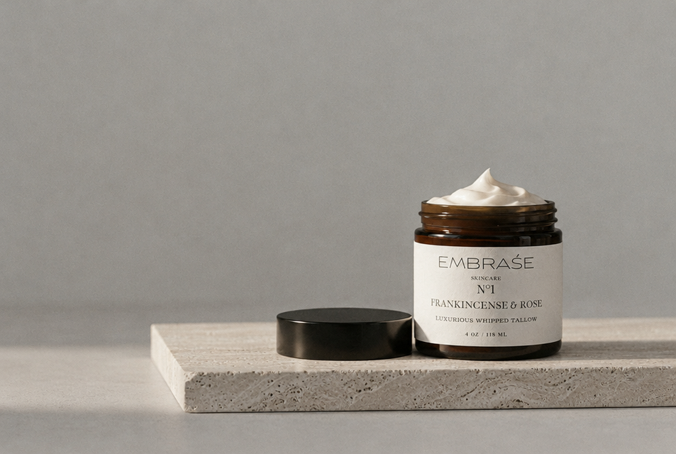 EMBRAŚE whipped tallow jar with lid off on travertine